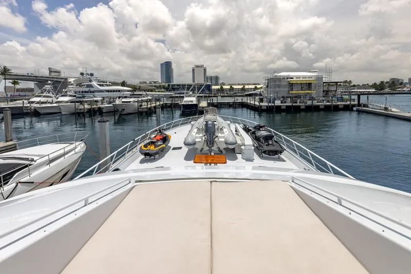 Slide: The Image of Luxurious 1998 Trinity Yachts model docked at a marina with clear skies. - 23