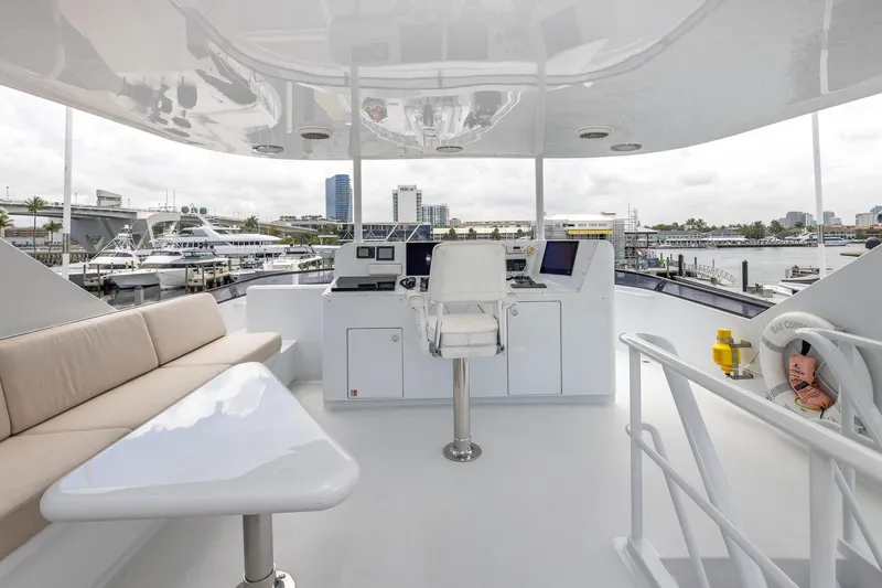 Slide: The Image of Luxurious 1998 Trinity Yachts deck with seating, control station, and marina view. - 55