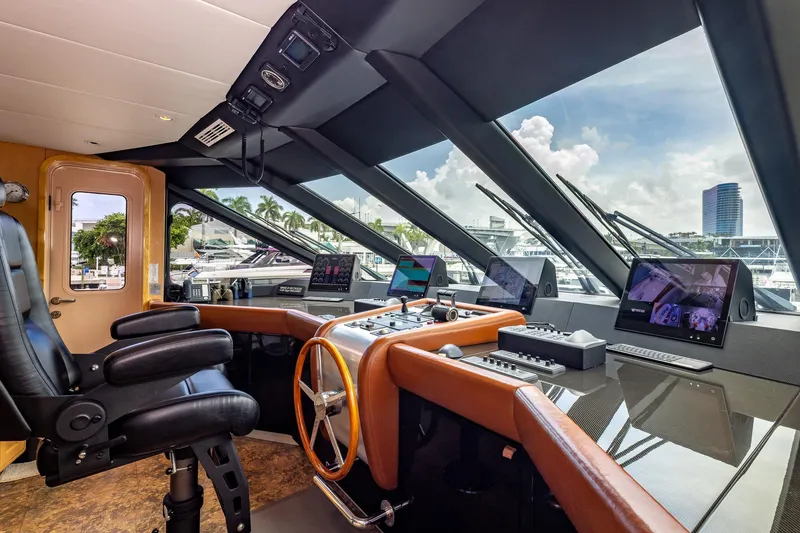 Slide: The Image of Luxurious 1998 Trinity Yachts helm with modern navigation equipment and panoramic windows. - 49