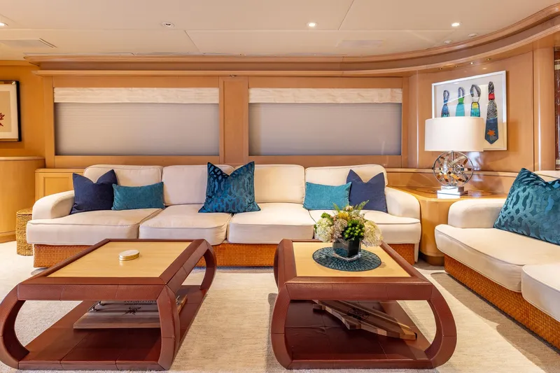 Slide: The Image of Luxurious yacht interior with elegant seating, decorative pillows, and stylish coffee tables, Trinity Yachts 1998. - 15