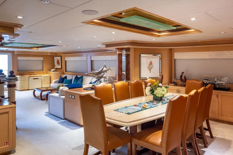 Slide: The Image of Luxurious interior of a 1998 Trinity Yachts model, featuring elegant dining and seating areas. - 18