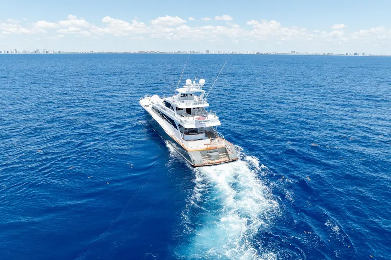 Slide: The Image of Luxurious 1998 Trinity Yachts model cruising on open blue ocean under clear skies. - 4