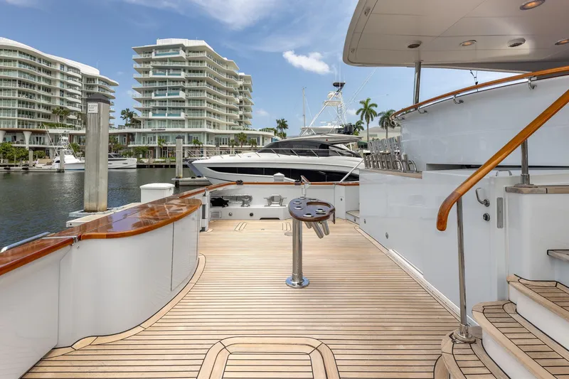 Slide: The Image of Luxurious 1998 Trinity Yachts deck with waterfront view and modern architecture. - 6