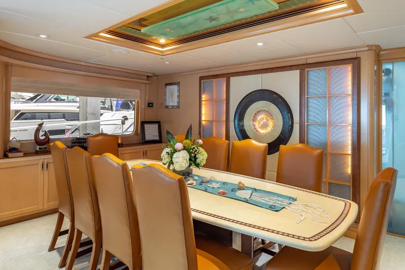 Slide: The Image of Luxurious dining area on a 1998 Trinity Yachts model, featuring elegant decor and seating. - 19