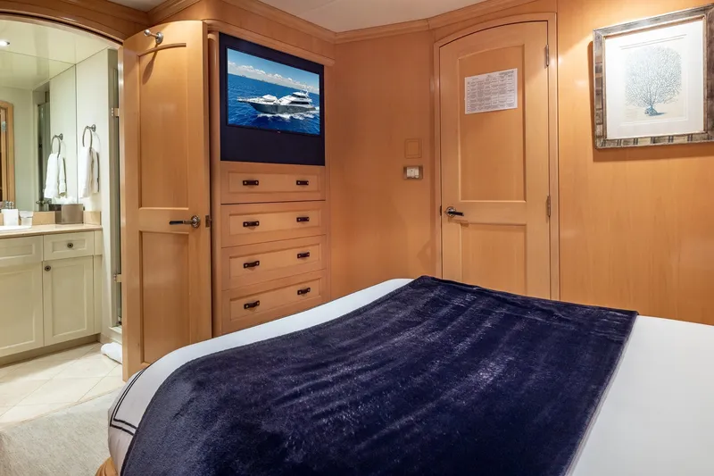 Slide: The Image of Luxurious bedroom interior on 1998 Trinity Yachts, featuring elegant wood paneling and modern amenities. - 33
