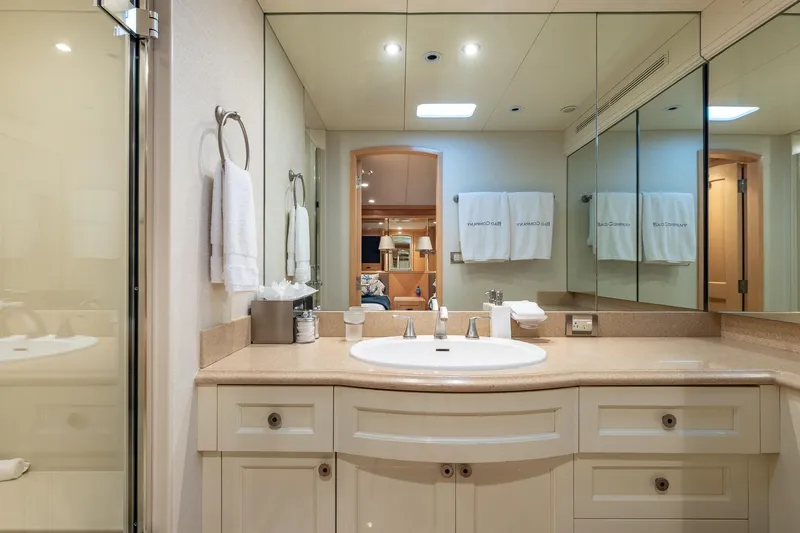 Slide: The Image of Luxurious yacht bathroom with mirrored walls, elegant sink, and plush towels, Trinity Yachts 1998 model. - 38