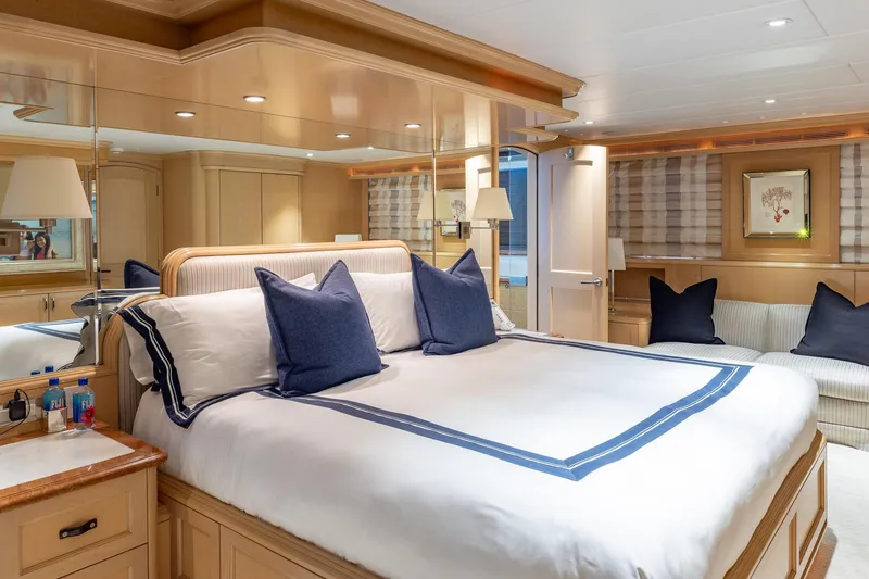Slide: The Image of Luxurious bedroom interior on a 1998 Trinity Yachts model, featuring elegant decor and plush bedding. - 27