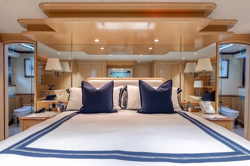 Slide: The Image of Luxurious bedroom interior on a 1998 Trinity Yachts model, featuring elegant bedding and decor. - 28