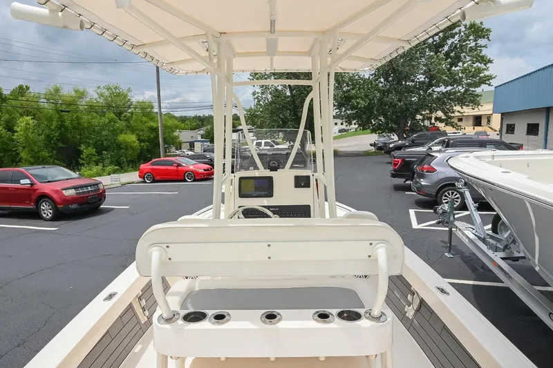 Slide: The Image of 2021 Pathfinder 2200 TRS boat in parking lot, surrounded by cars and trees. - 19