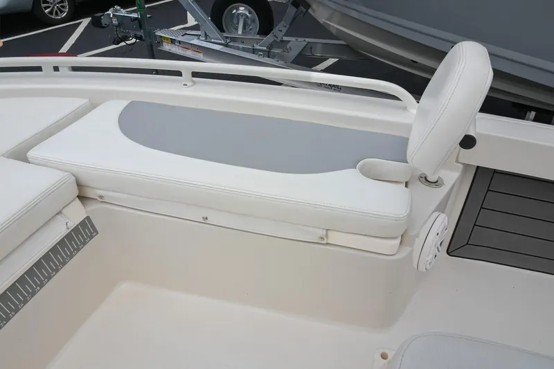 Slide: The Image of 2021 Pathfinder 2200 TRS boat interior with cushioned seating and cup holder. - 47