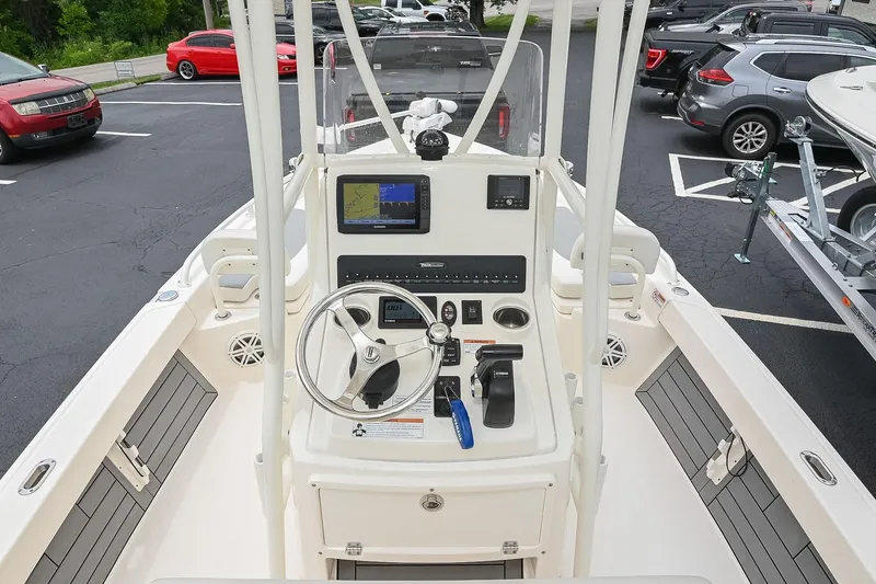 Slide: The Image of 2021 Pathfinder 2200 TRS boat dashboard with steering wheel and navigation display. - 29