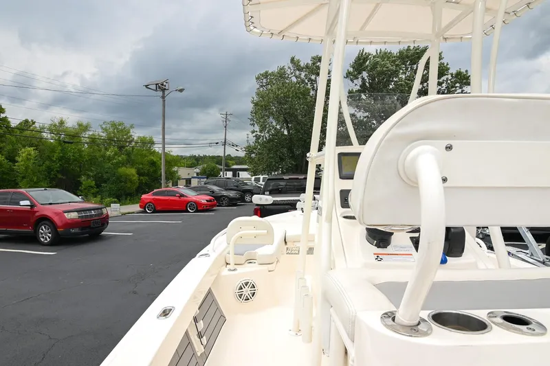 Slide: The Image of 2021 Pathfinder 2200 TRS boat parked near cars under cloudy sky. - 28