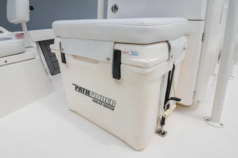 Slide: The Image of 2021 Pathfinder 2200 TRS boat cooler seat with white cushion and secure straps. - 44