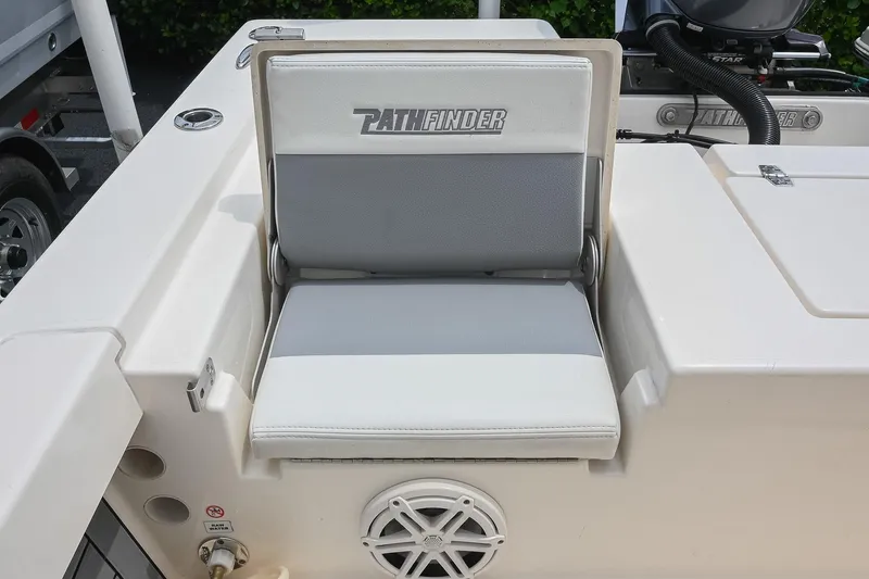 Slide: The Image of 2021 Pathfinder 2200 TRS boat seat with logo, featuring white and gray upholstery. - 24