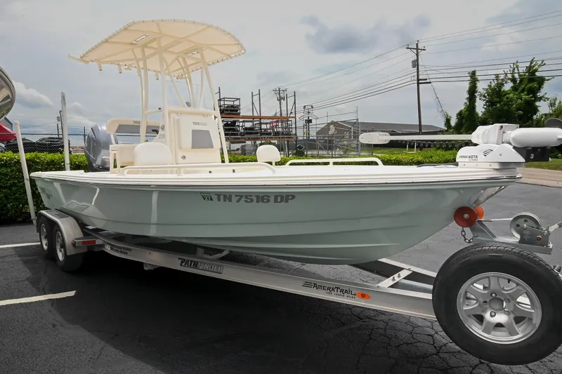 Slide: The Image of 2021 Pathfinder 2200 TRS boat on trailer in parking lot, overcast sky. - 16