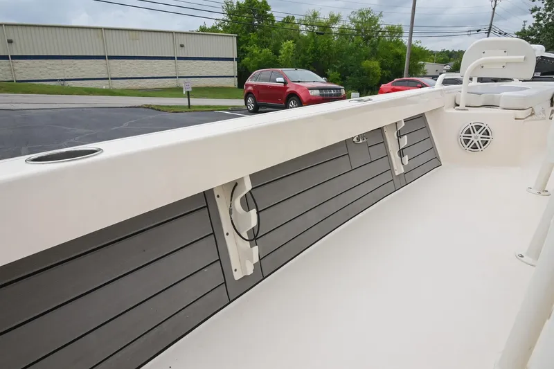 Slide: The Image of 2021 Pathfinder 2200 TRS boat interior with rod holders and speaker, parked outdoors. - 39