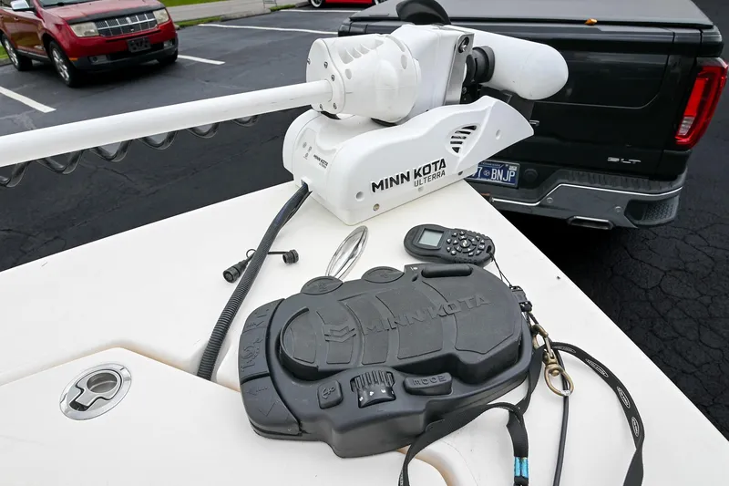 Slide: The Image of Minn Kota Ulterra motor on 2021 Pathfinder 2200 TRS boat, parked near vehicles. - 54