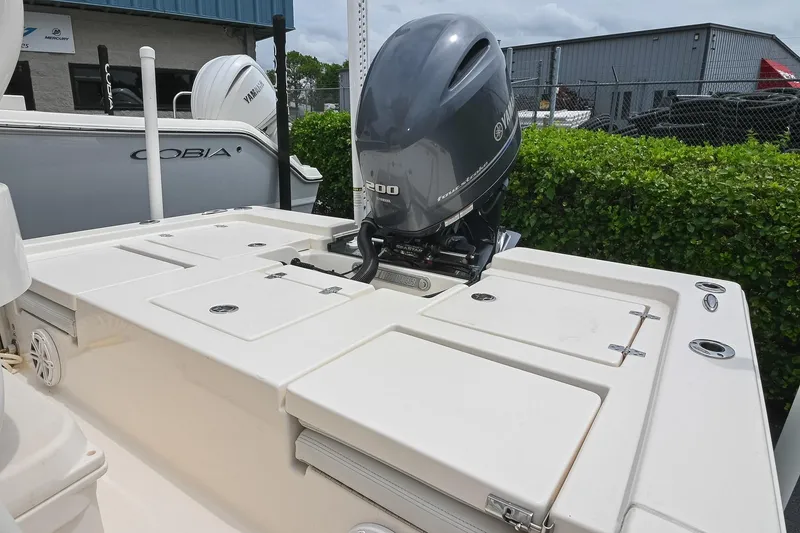 Slide: The Image of 2021 Pathfinder 2200 TRS boat with Yamaha outboard motor, docked near other boats. - 20