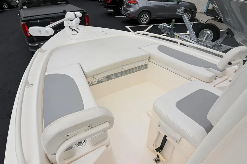 Slide: The Image of 2021 Pathfinder 2200 TRS boat interior with cushioned seating and fishing gear. - 41