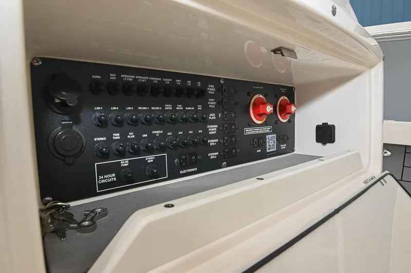 Slide: The Image of Control panel of a 2021 Pathfinder 2200 TRS boat, featuring various switches and dials. - 30