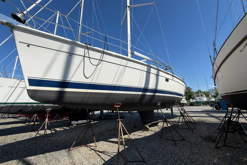 The Image of 2007 Hunter 45 Center Cockpit sailboat on stands in a boatyard. - 0