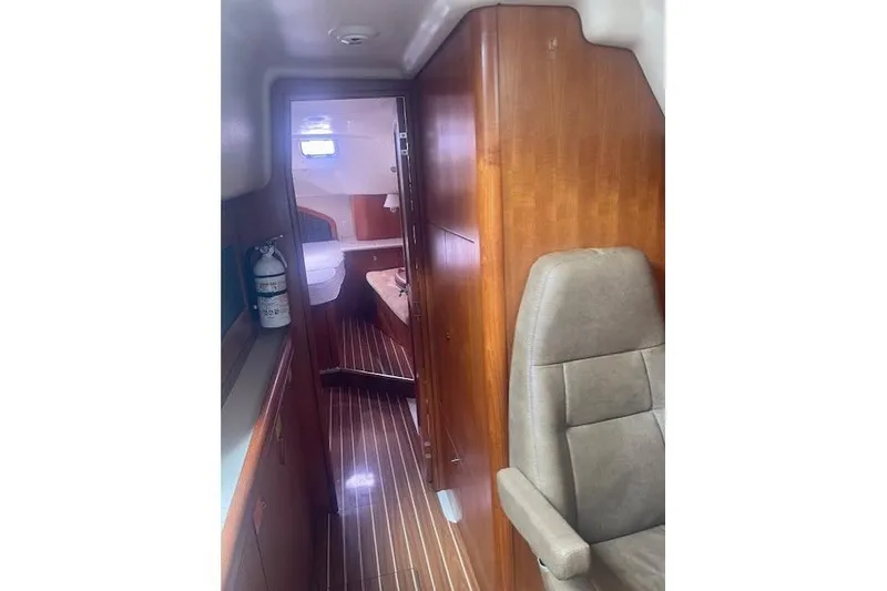 Slide: The Image of Interior of 2007 Hunter 45 Center Cockpit yacht with wood paneling and seating. - 13