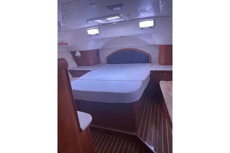 Slide: The Image of Interior cabin of 2007 Hunter 45 Center Cockpit yacht with bed and wooden finish. - 14