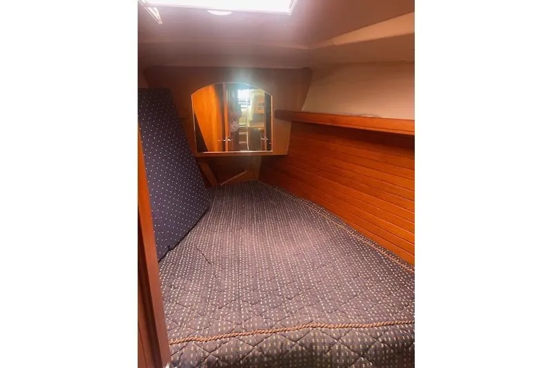 Slide: The Image of Cozy cabin interior of 2007 Hunter 45 Center Cockpit sailboat with wooden paneling. - 19
