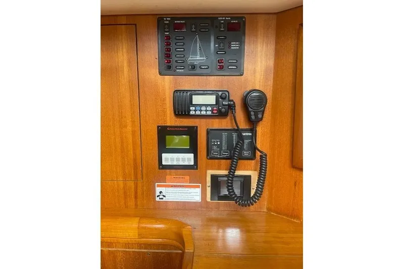 Slide: The Image of Control panel of a 2007 Hunter 45 Center Cockpit sailboat with communication equipment. - 21