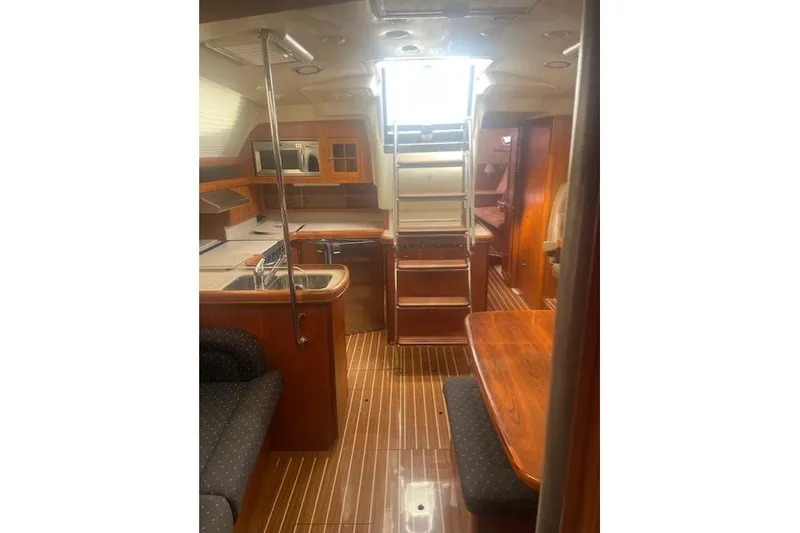 Slide: The Image of Interior of 2007 Hunter 45 Center Cockpit yacht with wood finish and modern amenities. - 8