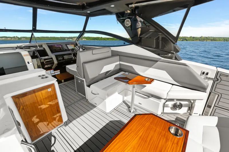 Slide: The Image of Luxurious interior of 2020 Cruisers Yachts 38 GLS OB with sleek seating and wooden accents. - 10