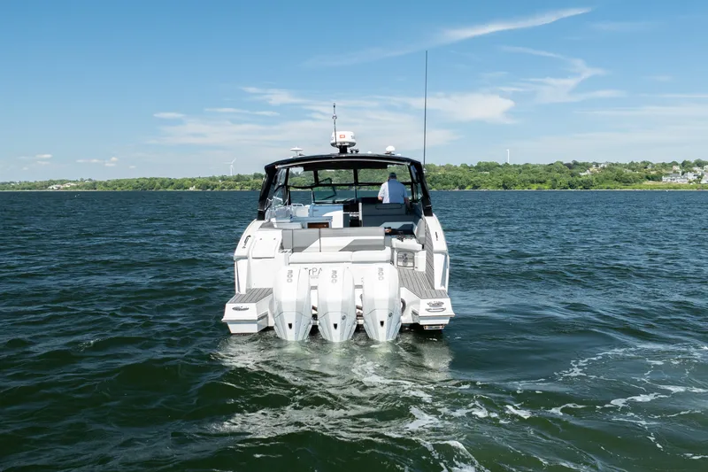 Slide: The Image of 2020 Cruisers Yachts 38 GLS OB on open water, rear view with triple outboard engines. - 3