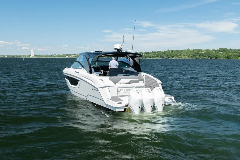 Slide: The Image of 2020 Cruisers Yachts 38 GLS OB on open water, rear view with triple outboard engines. - 4