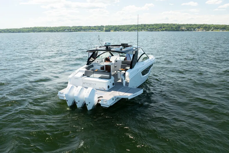 Slide: The Image of 2020 Cruisers Yachts 38 GLS OB on open water, showcasing sleek design and triple outboard engines. - 5