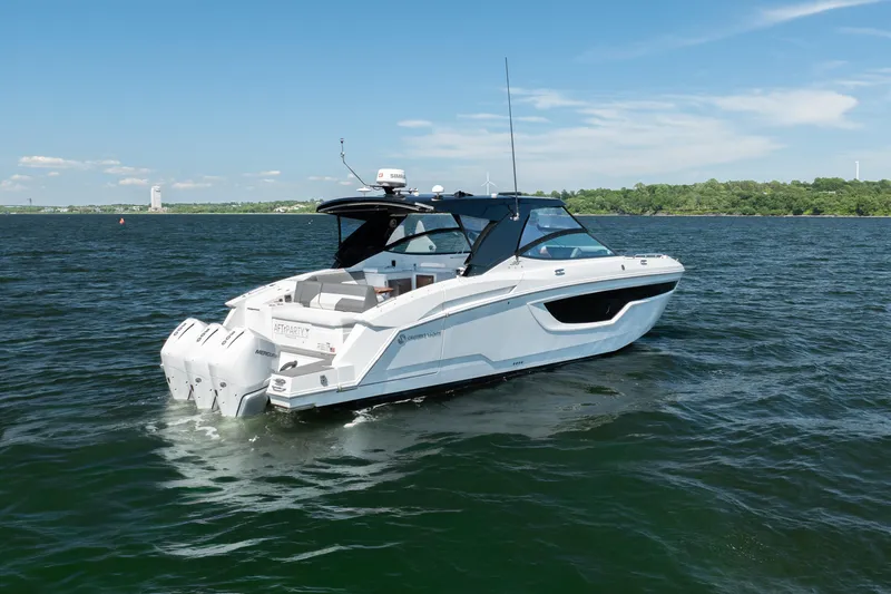 Slide: The Image of 2020 Cruisers Yachts 38 GLS OB on open water, showcasing sleek design and powerful engines. - 2