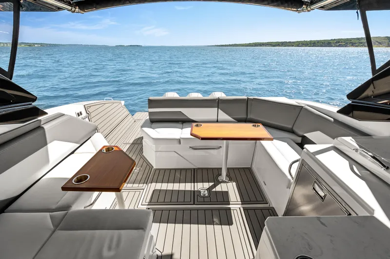 Slide: The Image of Luxurious 2020 Cruisers Yachts 38 GLS OB interior with ocean view, featuring elegant seating and tables. - 12