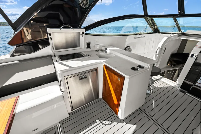 Slide: The Image of Luxurious 2020 Cruisers Yachts 38 GLS OB interior with sleek kitchenette and ocean view. - 13