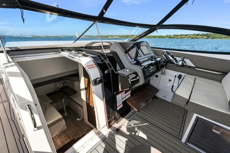 Slide: The Image of 2020 Cruisers Yachts 38 GLS OB cockpit with modern helm and cabin entry. - 7