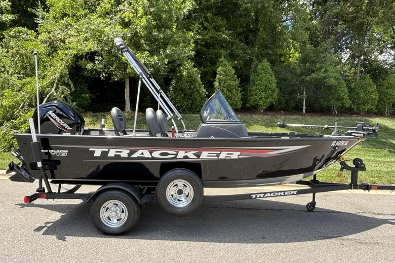The Image of 2025 Tracker Pro Guide V-16 WT boat on trailer, parked outdoors. - 1