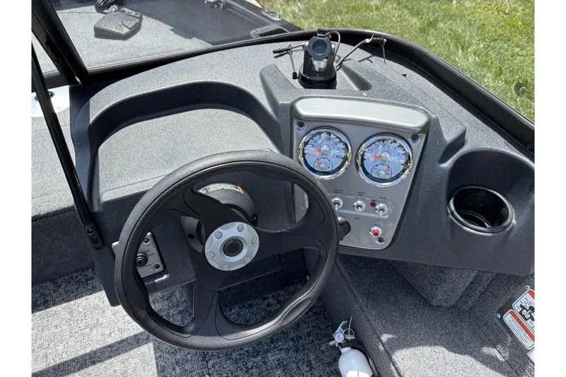 Slide: The Image of 2025 Tracker Pro Guide V-16 WT boat dashboard with steering wheel and gauges. - 20