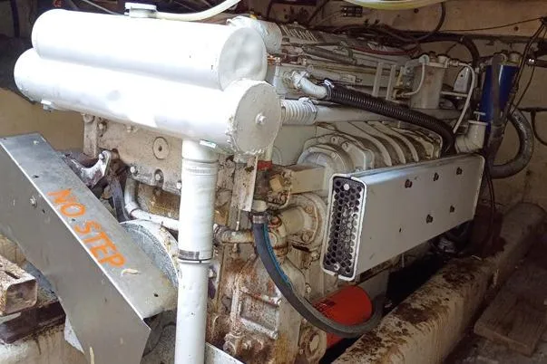 Slide: The Image of Engine room of a 1980 Thompson Passenger and Dive Trawler, featuring a robust marine engine. - 10