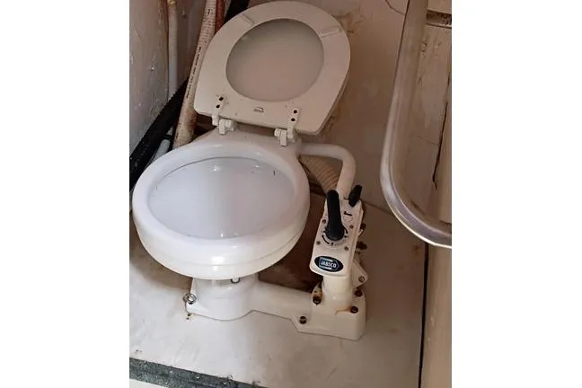 Slide: The Image of Marine toilet in a 1980 Thompson Passenger and Dive Trawler bathroom. - 11