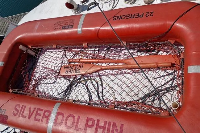 Slide: The Image of Life raft labeled "Silver Dolphin" on 1980 Thompson trawler, capacity 22 persons. - 13