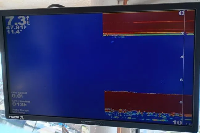 Slide: The Image of Fishfinder display on 1980 Thompson Passenger and Dive Trawler, showing depth and sonar readings. - 9