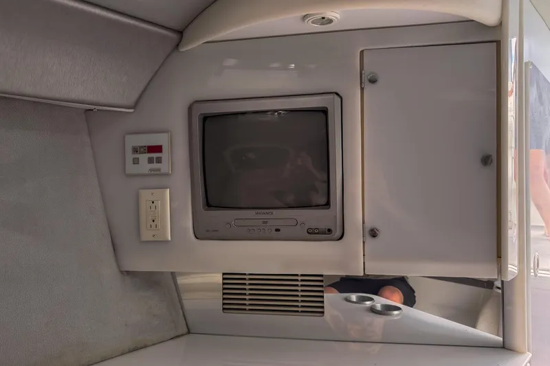 Slide: The Image of 2002 Formula 382 FASTech cabin interior with TV and storage cabinet. - 11
