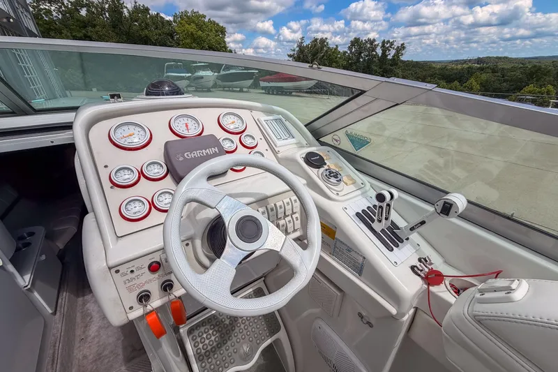 Slide: The Image of Cockpit of 2002 Formula 382 FASTech boat with steering wheel and control panel. - 12