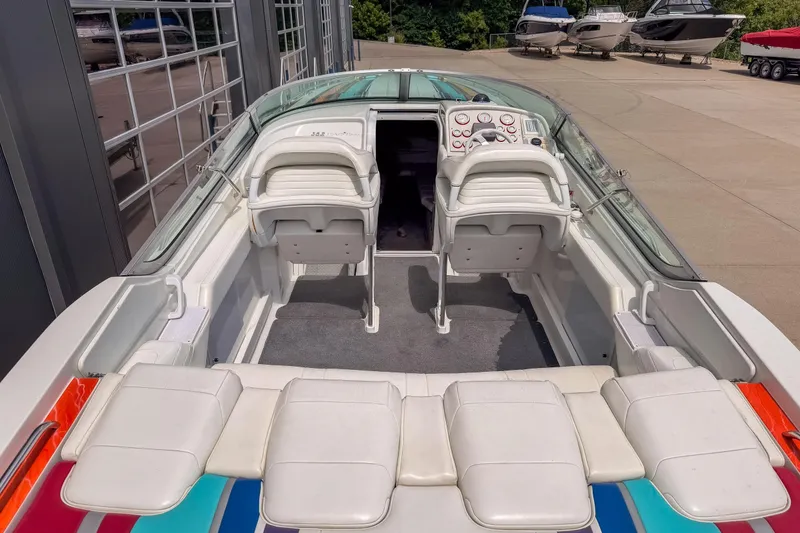 Slide: The Image of 2002 Formula 382 FASTech boat interior with white seating and colorful accents. - 14