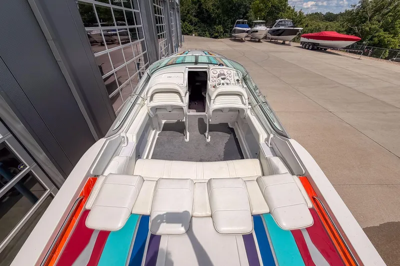 Slide: The Image of 2002 Formula 382 FASTech boat with colorful upholstery, docked near other boats. - 15