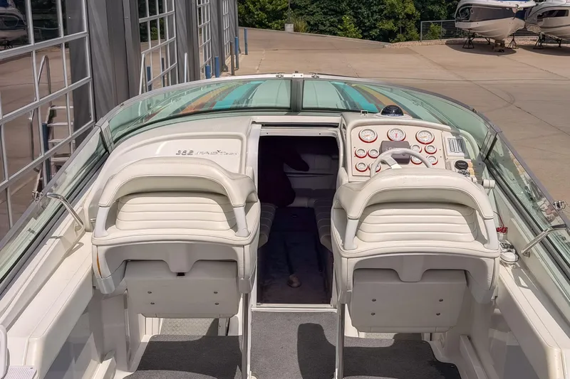 Slide: The Image of 2002 Formula 382 FASTech boat interior with white seating and dashboard controls. - 16