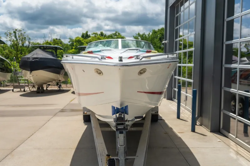 Slide: The Image of 2002 Formula 382 FASTech boat on trailer, parked outdoors near a building. - 2